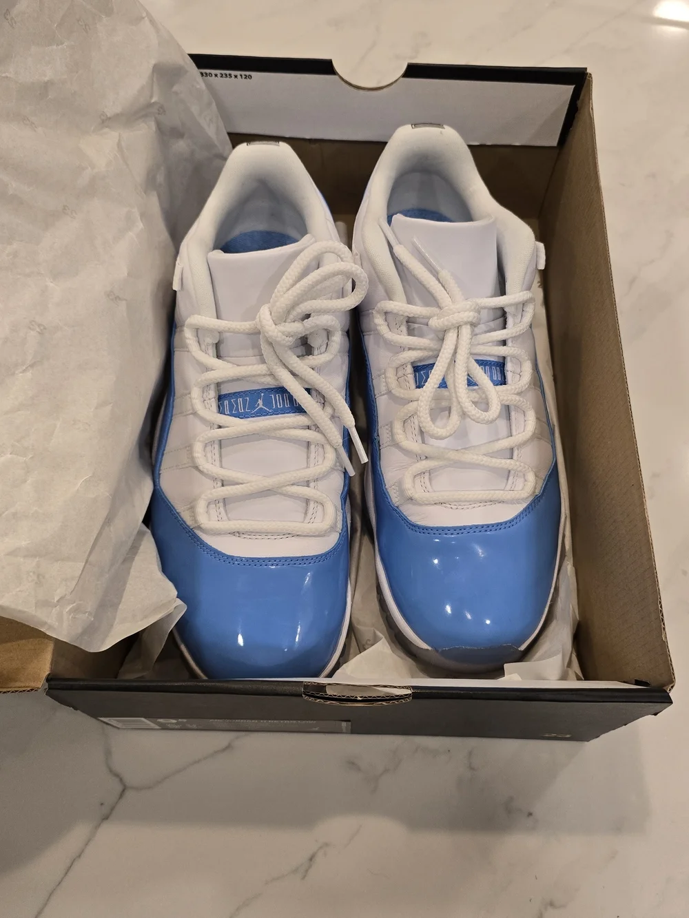 Air Jordan 11 Low Retro White and University Blue Sneakers